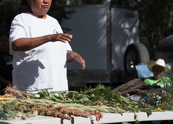 Woman selling flowers and crops