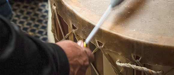 Person playing traditional drum